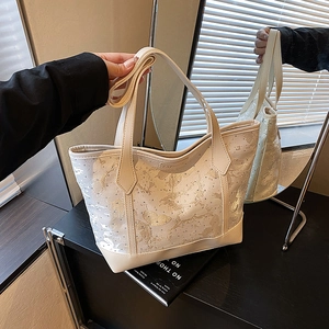 Chic beige tote bag with artistic gold print and adjustable strap for daily use