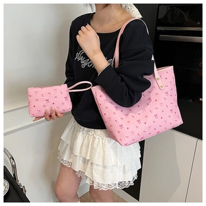 Detail of pink floral canvas tote bag and mini coin purse set with bow pattern