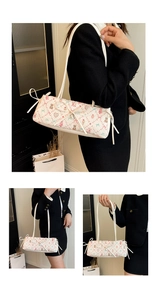 Detail of white shoulder bag featuring cute cartoon bear prints and ribbon bow decoration
