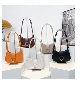 Detailed display of vintage half-moon bags in five colors with golden horseshoe buckles