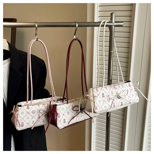 Detailed view of three small square bags with bear print and cute ribbon bow accents
