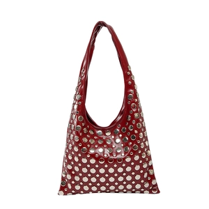 Fashionable red patent leather hobo bag with silver punk rivets and a stylish handle