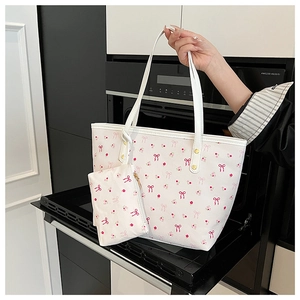 Detail of white tote bag with pink butterfly floral print and matching coin purse