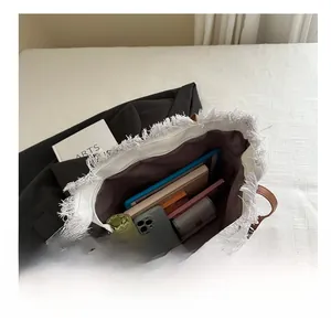 Top view of large tote bag showing spacious interior with fringe and daily essentials