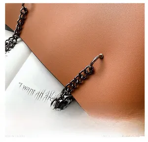 Detailed macro view of caramel brown lychee leather texture and dark gray metal chain strap