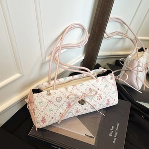 Quilted white shoulder bag with floral bear print and pink bow detail in mirror view