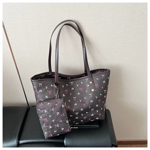 Detail of waterproof brown tote with pink bows and white floral patterns with a mini pouch