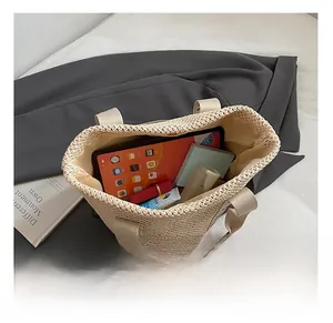 Interior view of beige woven tote bag showing spacious capacity for tablets and cosmetics