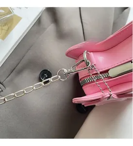 Detailed close-up of premium silver-tone hardware and lobster clasp on pink mini bag