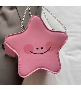 Detail of pink star-shaped crossbody bag featuring a soft PU texture and silver chain strap