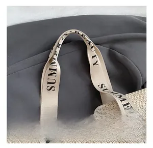 Close-up of woven straw tote bag with printed summer beauty decorative handles