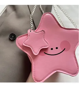Detail of pink star-shaped crossbody bag with silver chain and cute face print