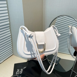 White crescent underarm bag with gold horseshoe buckle and knotted shoulder strap detail
