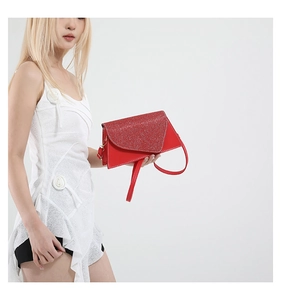 Detail of red handbag with luxury sequin flap and smooth leather contrast texture