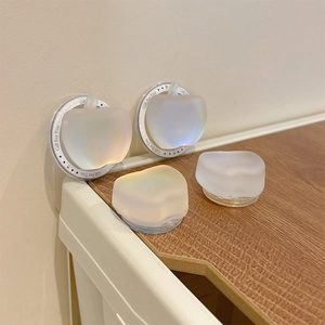 Close-up of translucent iridescent apple-shaped phone grip with Gift For You text base