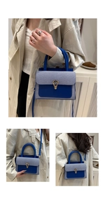 Detail of blue and white striped patchwork bag with golden snake head lock and handle