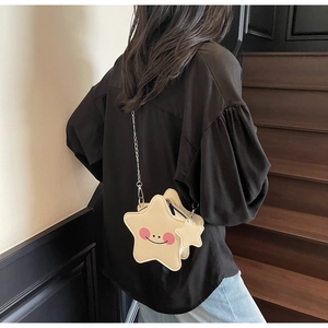 Detailed back view of a star-shaped crossbody bag with a smiley face and metal chain