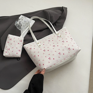 White leather tote bag set with pink bow and floral print, including a mini matching pouch