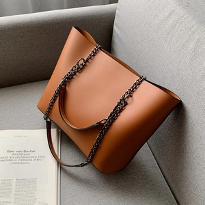 Brown leather tote bag with chain strap and handle, minimalist style for daily commuting