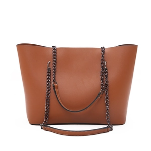 Classic large brown leather tote bag with elegant black metal chain straps for women