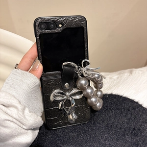 Detail of crocodile texture phone case with silver bow and pearl strap for Z Flip