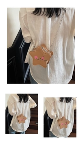 Detailed view of mini star-shaped crossbody bag with smiling face and chain strap