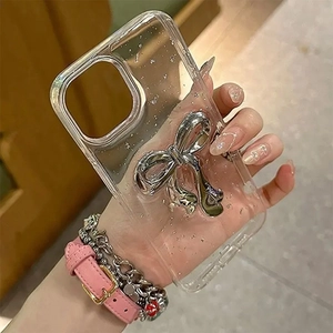 Detail view of transparent iPhone case with silver 3D bow and sparkling foil glitter
