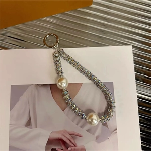 Short wrist strap phone charm featuring large pearls and rainbow rhinestone spacers