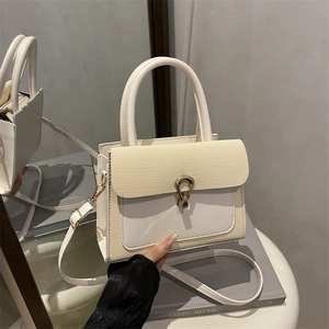 Chic two-tone structured handbag with woven texture flap and golden horseshoe buckle