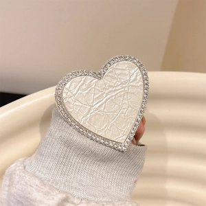 Detailed view of champagne gold leather heart phone socket with double rhinestone borders