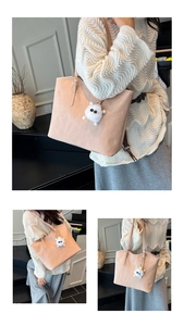 Detail of light pink tote bag featuring cartoon bear embossing and plush charm