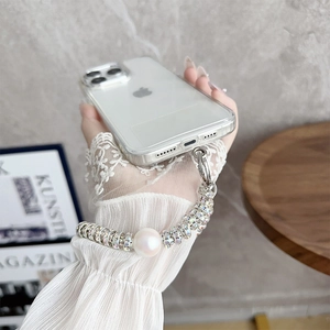 Luxury iPhone case with large faux pearl and rhinestone lanyard held by a hand