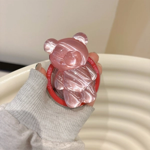 Detail of pink jelly bear phone socket with Good Luck engraving and cat-eye finish