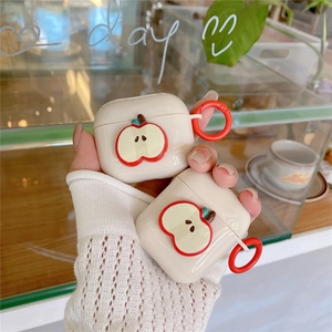Minimalist cream white AirPods case with 3D red apple design and matching red carabiner clip