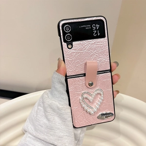 Macro shot of pink pleated leather case for Z Flip with pearl heart and rhinestone detail