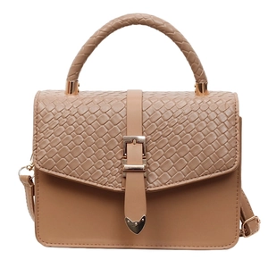 Chic beige crossbody bag with woven flap detail and top handle on white background