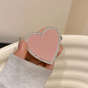 Pink heart phone grip with faux leather texture and sparkling crystal rhinestones border