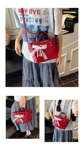 Red patent leather bucket bag with lace bow and pearls, showing handheld and crossbody styles