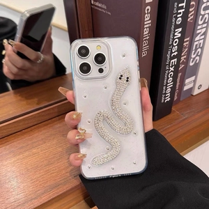 Close-up of sparkling rhinestone snake pattern on transparent iPhone case held by hand