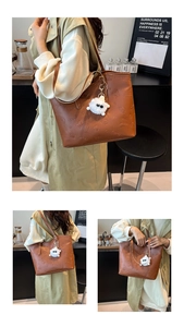 Detail of vintage brown leather tote bag with floral embossing and plush lamb charm