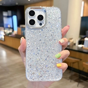 Glittery silver sequin phone case for iPhone shown held by a hand in a cafe setting