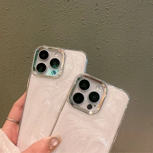 Detail view of white pearl glitter phone case with silver metallic camera lens frame