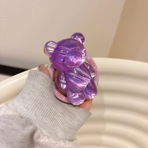 Close-up of purple translucent bear phone grip with Good Luck slogan and aurora gloss
