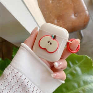 Detail shot of a cream silicone earphone case with apple motif and red carrying ring