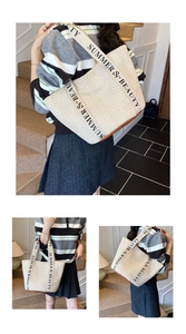 Detailed close-up of woven straw tote bag with canvas strap and brown leather reinforced base