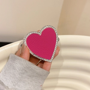 Detail of heart-shaped fuchsia leather phone socket with sparkling rhinestone border