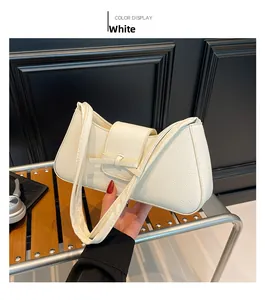 Close-up of white crescent underarm bag with lychee texture and bow buckle