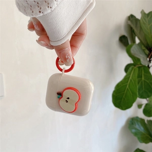 Detail view of beige silicone case for AirPods with 3D red apple design and finger ring