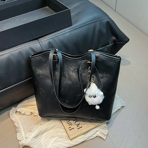 Retro black PU leather tote bag with embossed butterfly patterns and a plush monster charm