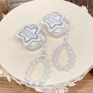Detail of clear AirPods case with Shiny Star motif and white pearl beaded wrist strap